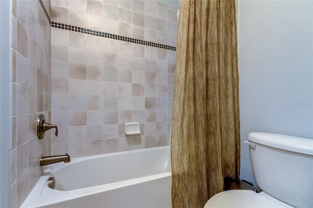 bathroom featuring shower / bath combo and toilet