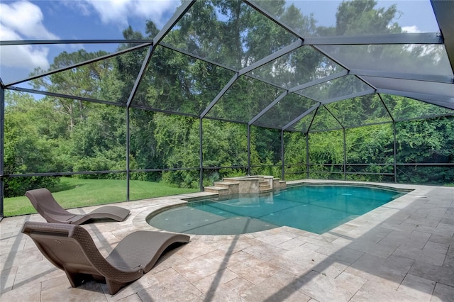 view of pool with glass enclosure and a patio area