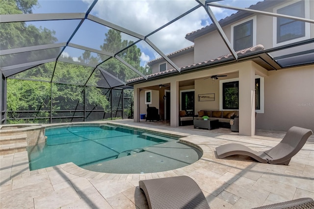 view of swimming pool featuring a patio area, ceiling fan, glass enclosure, and an outdoor living space