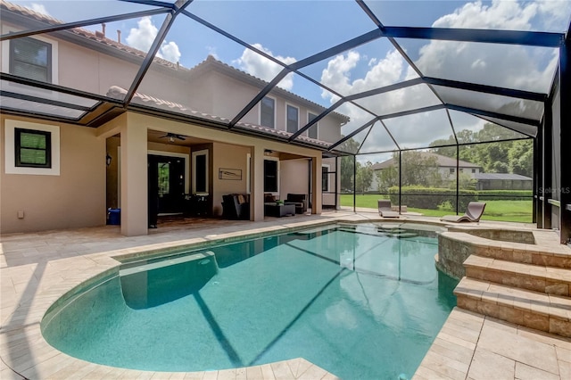 view of swimming pool with a lanai, ceiling fan, and a patio