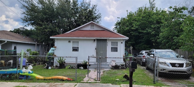 bungalow-style house with a front yard