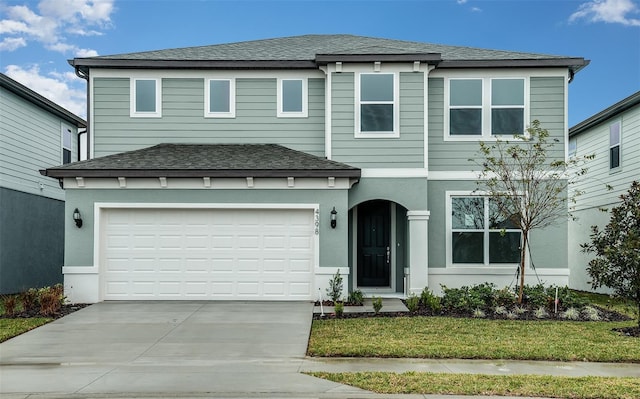 view of front facade with a front lawn and a garage