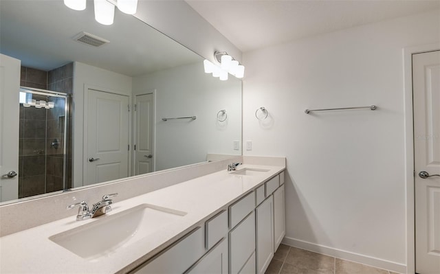 bathroom featuring tile patterned floors, vanity, and an enclosed shower