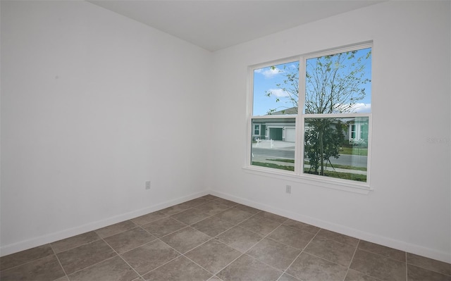 unfurnished room featuring tile patterned floors