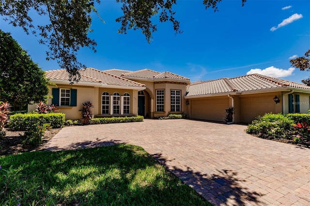 mediterranean / spanish home with a garage