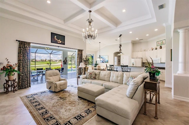 tiled living room with beam ceiling, coffered ceiling, a notable chandelier, and ornate columns