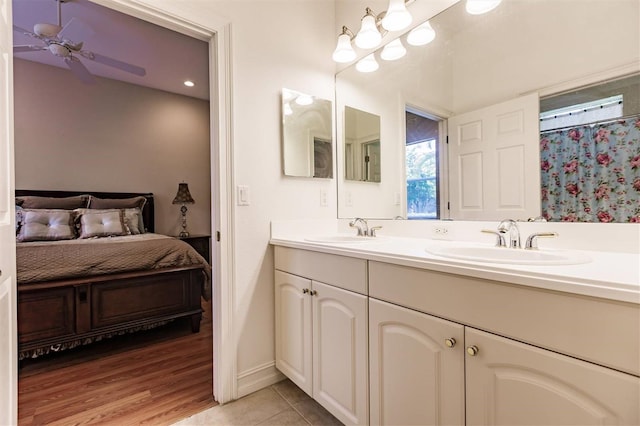 bathroom featuring ceiling fan, dual bowl vanity, and tile patterned floors