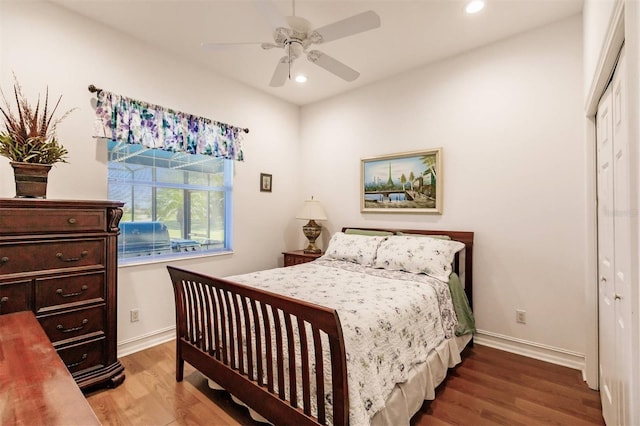 bedroom featuring ceiling fan, wood-type flooring, and a closet