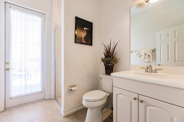 bathroom featuring tile patterned floors, a wealth of natural light, vanity, and toilet