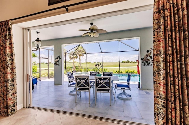 interior space featuring glass enclosure and ceiling fan