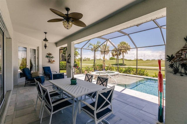 view of patio / terrace with ceiling fan and a lanai