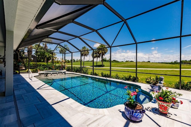 view of pool featuring a patio area, an in ground hot tub, a yard, and glass enclosure