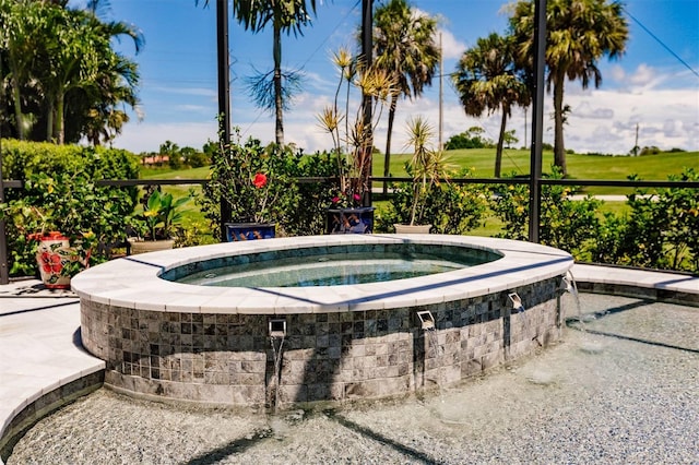 view of swimming pool with an in ground hot tub