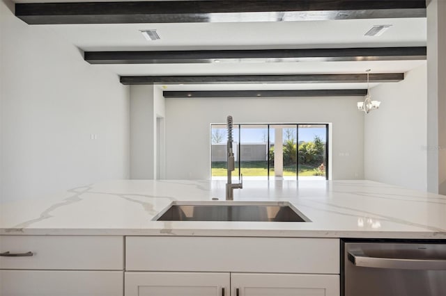 kitchen featuring dishwasher, white cabinets, light stone countertops, and beamed ceiling