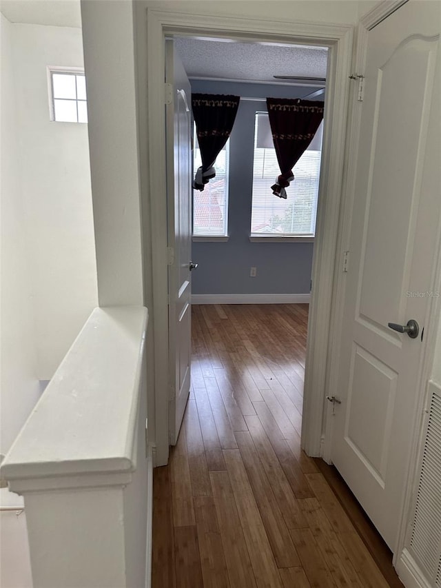 hallway with hardwood / wood-style flooring