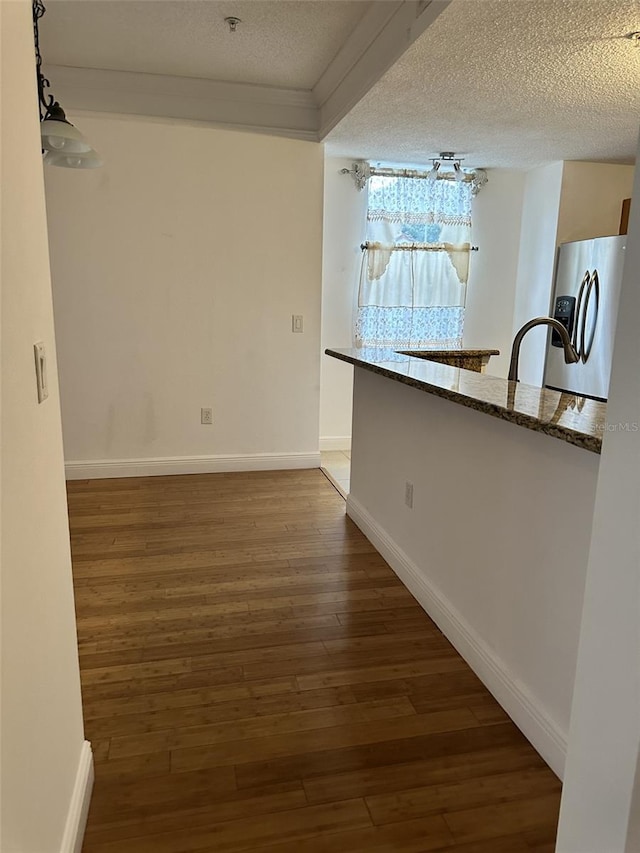 interior space featuring dark wood-type flooring and a textured ceiling