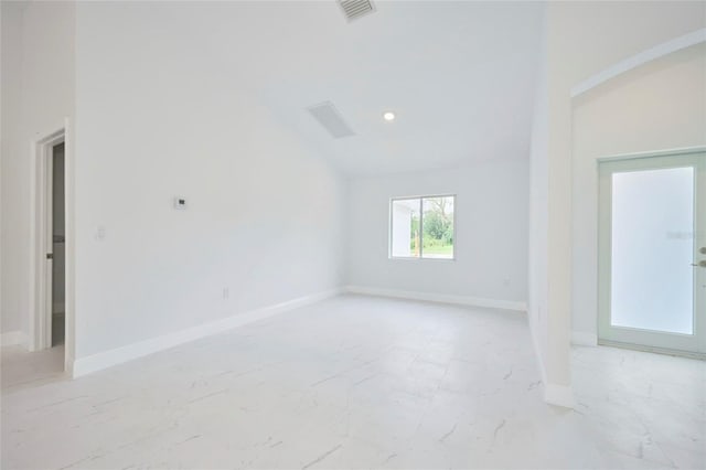 unfurnished room featuring vaulted ceiling