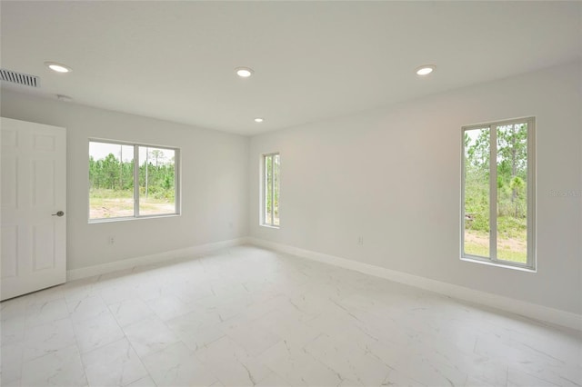 unfurnished room featuring a wealth of natural light