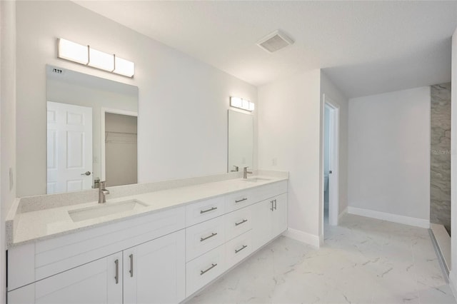 bathroom featuring vanity and a textured ceiling