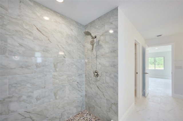 bathroom featuring tiled shower