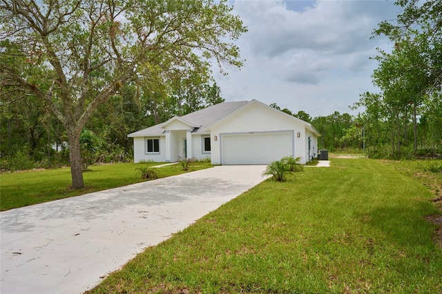 ranch-style house featuring a garage, cooling unit, and a front lawn