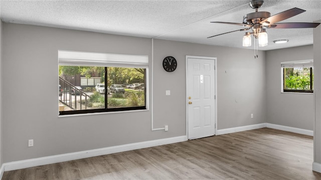 entrance foyer with ceiling fan, hardwood / wood-style floors, and a textured ceiling