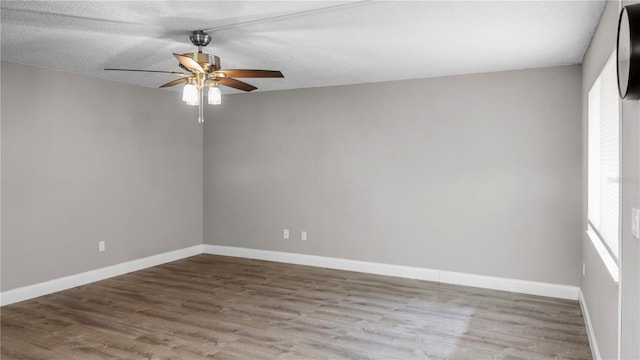 spare room featuring hardwood / wood-style floors, a textured ceiling, and ceiling fan