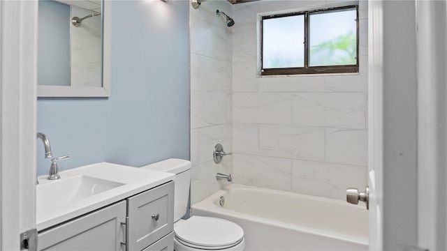 full bathroom featuring tiled shower / bath, vanity, and toilet