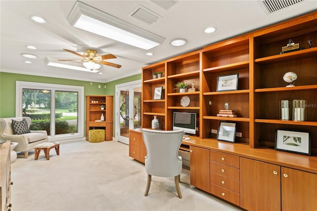 carpeted office space with ceiling fan and crown molding