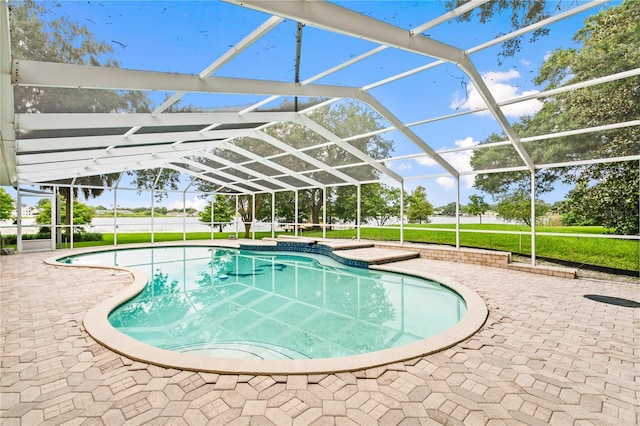 view of swimming pool with a patio area and a lanai