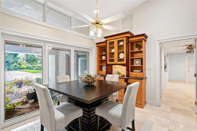 dining room with high vaulted ceiling and ceiling fan