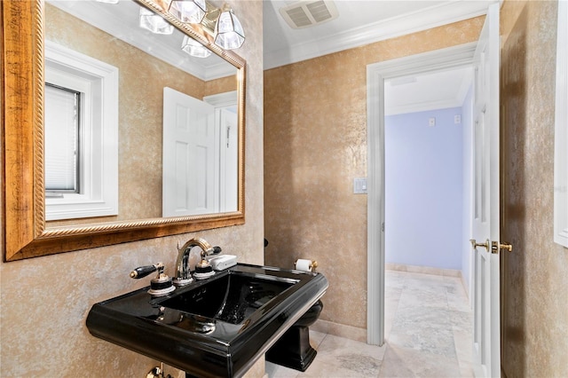 bathroom with sink and ornamental molding