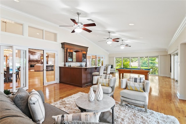 living room featuring lofted ceiling, light wood-type flooring, crown molding, and billiards