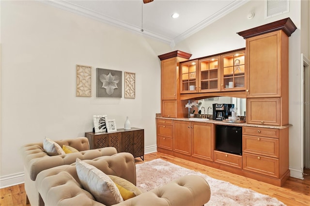 bar with sink, black dishwasher, crown molding, light hardwood / wood-style floors, and vaulted ceiling