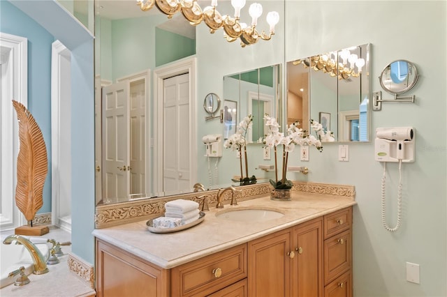 bathroom with a notable chandelier and vanity