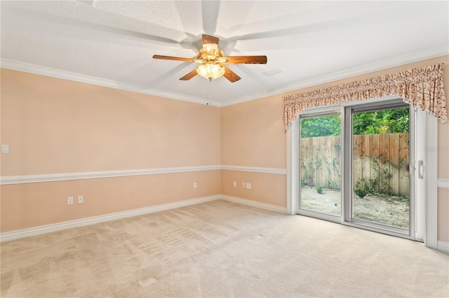 carpeted empty room featuring a textured ceiling, ceiling fan, and crown molding