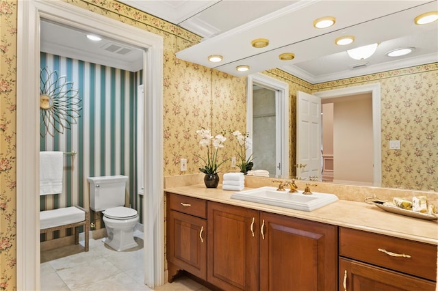 bathroom with vanity, toilet, and ornamental molding