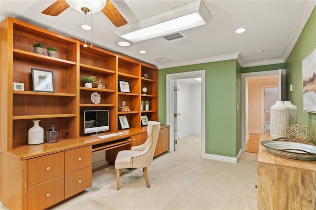 carpeted office with built in desk, ceiling fan, and crown molding