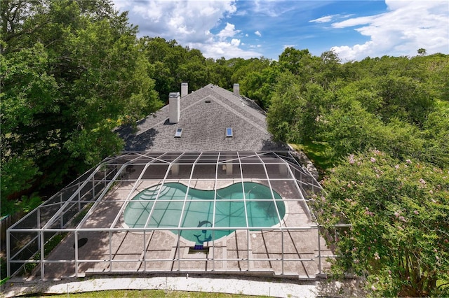 view of swimming pool with a lanai and a patio