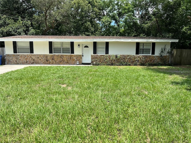 ranch-style home with a front lawn