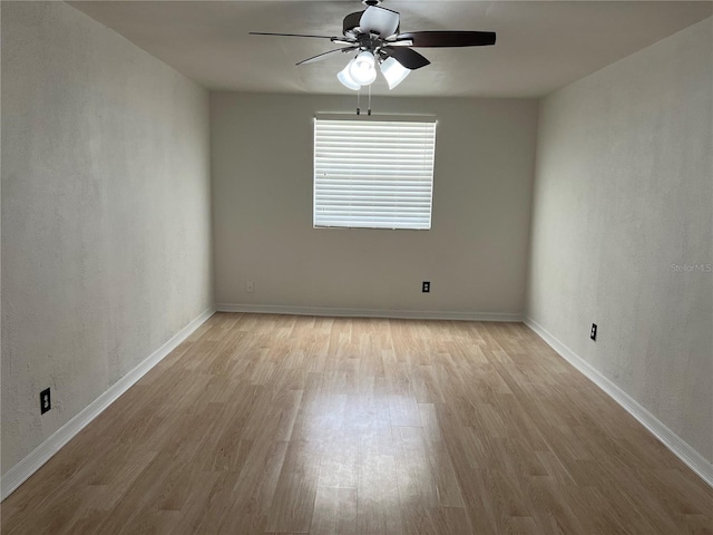 spare room with light hardwood / wood-style floors and ceiling fan