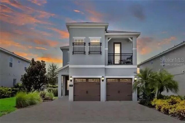 view of front facade with a balcony and a garage