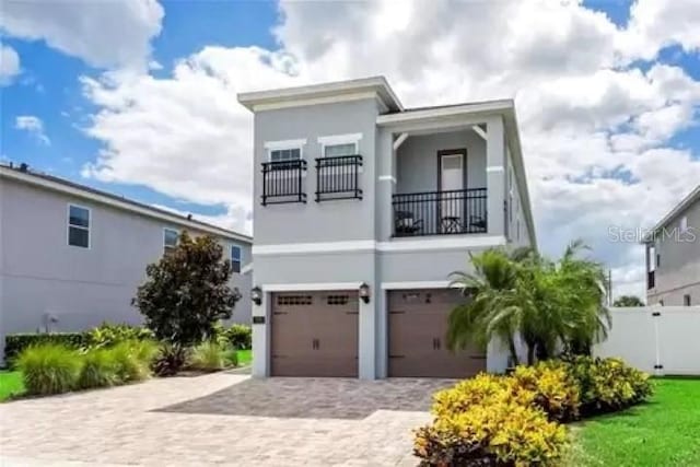 view of front of property with a garage and a balcony