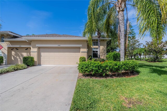 view of front of property with a garage and a front lawn