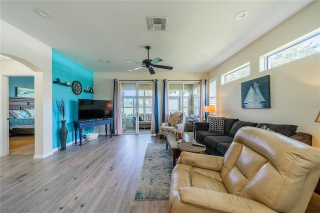 living room featuring wood-type flooring and ceiling fan