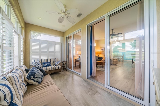 sunroom featuring ceiling fan