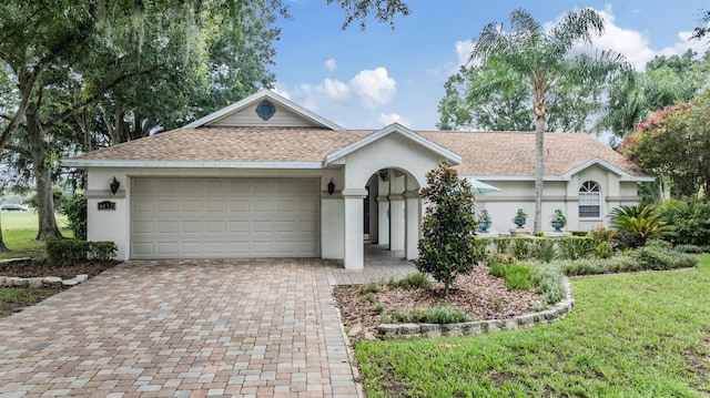 ranch-style home with a garage and a front yard