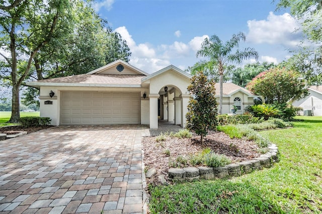 ranch-style home featuring a garage and a front lawn