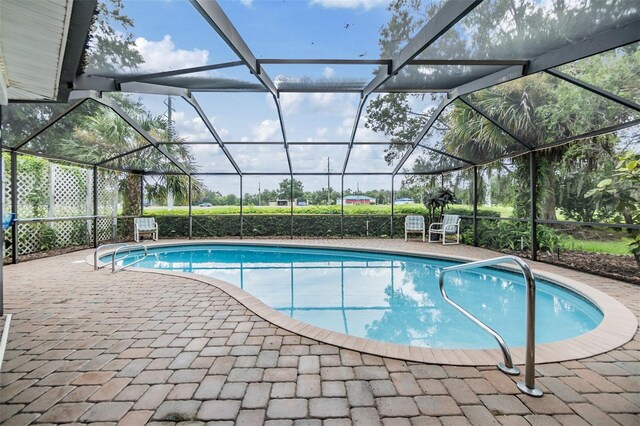 view of pool featuring a patio and glass enclosure