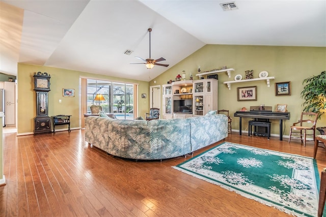 living room with lofted ceiling, ceiling fan, and hardwood / wood-style floors